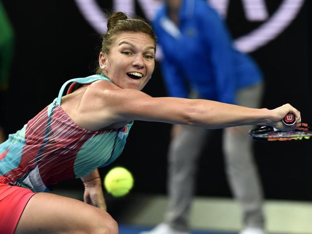 Simona Halep of Romania reaches for backhand return to Zhang Shuai of China during their first round match. (Andrew Brownbill/ AP Photo) 