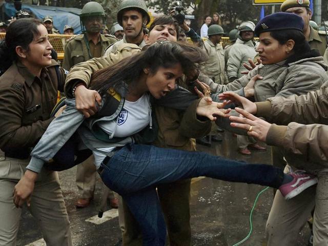 Police detain a girl student during a protest against HRD ministry in Delhi.  (PTI ) 