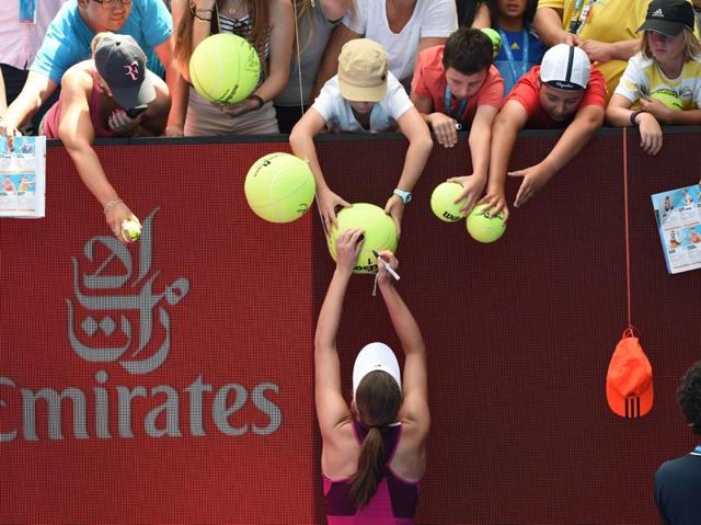 Britain's Johanna Konta signs autographs as she celebrates after victory in her women's singles match against Venus Williams of the US. (William West/ AFP PHOTO ) 