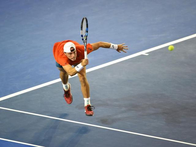 Australia's James Duckworth plays a backhand return during his men's singles match against compatriot Lleyton Hewitt . ( William West/ AFP PHOTO ) 