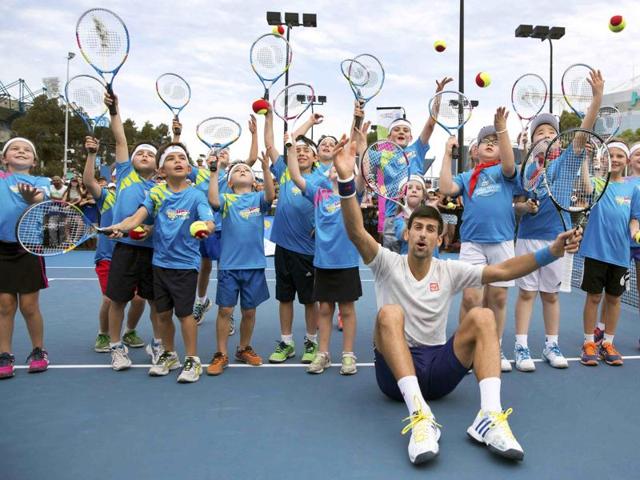 Serbia's Novak Djokovic poses with ANZ Tennis Hot Shots participants from Melbourne and Shanghai during a promotional event at the Australian Open tennis tournament . (REUTERS) 