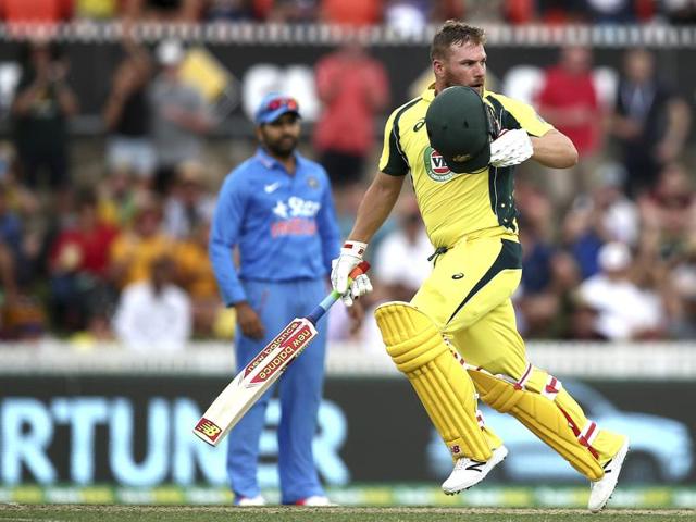 Australian batsman Aaron Finch takes his helmet off to celebrate his century. (AP Photo) 
