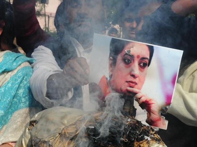 Congress workers burn HRD minister Smriti Irani’s photograph during a protest in Bhopal on Wednesday. (Mujeeb Faruqui/HT Photo) Congress workers burn HRD minister Smriti Irani’s photograph during a protest in Bhopal on Wednesday. (Mujeeb Faruqui/HT Photo)