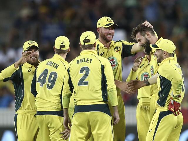 Australia's Kane Richardson, second from right, is congratulated by teammates after taking a wicket during their ODI against India in Canberra on January 20, 2016. (AP Photo) 