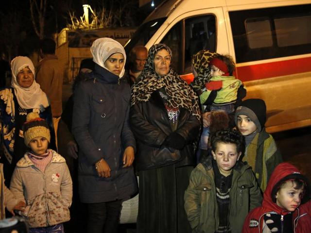 People wait to leave the besieged town of Madaya, northwest of Damascus, Syria. In the besieged eastern city of Deir el-Zour, supplies are running so short that people are selling their gold and other property for food or an exit permit allowing them to escape both the government and Islamic State militants who rule the region of Syria. (AP Photo) People wait to leave the besieged town of Madaya, northwest of Damascus, Syria. In the besieged eastern city of Deir el-Zour, supplies are running so short that people are selling their gold and other property for food or an exit permit allowing them to escape both the government and Islamic State militants who rule the region of Syria. (AP Photo)