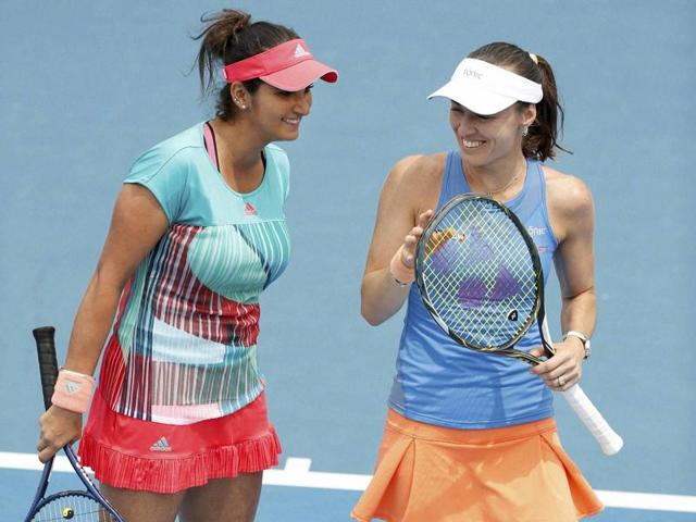 Switzerland's Martina Hingis, right, and India's Sania Mirza celebrate a point during their first round match against Brazil's Teliana Pereira and Colombia's Mariana Duque-Marino. (AP Photo)