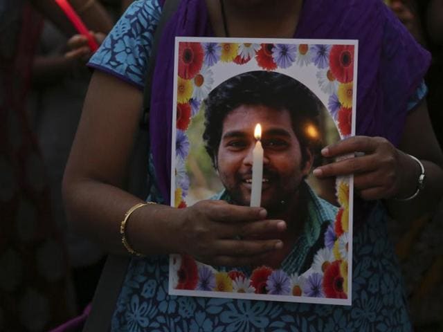 Activist of a Dalit organization participate in a candle light vigil holding photographs of Indian student Rohith Vemula in Hyderabad.(AP) Activist of a Dalit organization participate in a candle light vigil holding photographs of Indian student Rohith Vemula in Hyderabad.(AP)