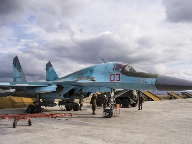 A Russian air force technician reports to a pilot that a bomber is ready for a combat mission at Hemeimeem air base in Syria. Russian warplanes have flown over 5,700 combat missions since Moscow launched its air campaign in Syria.(AP Photo)