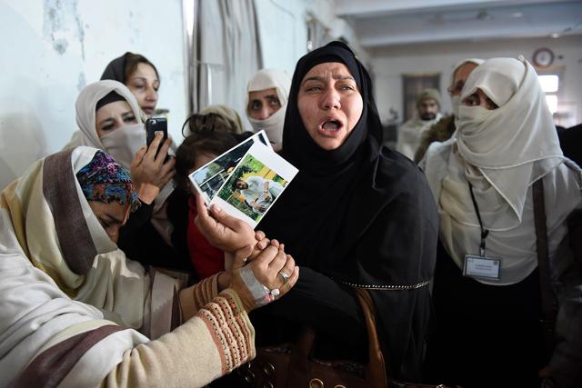 A relative of a 2014 Peshawar school attack victim shows her son's pictures to a student victim (L) of the Bacha Khan University attack at a hospital in Charsadda. (AFP) A relative of a 2014 Peshawar school attack victim shows her son's pictures to a student victim (L) of the Bacha Khan University attack at a hospital in Charsadda. (AFP)