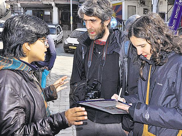 An activist of the Students for Free Tibet getting signature of a foreigner during a campaign in Dharamshala on Thursday. (Shyam Sharma/HT Photo) An activist of the Students for Free Tibet getting signature of a foreigner during a campaign in Dharamshala on Thursday. (Shyam Sharma/HT Photo)