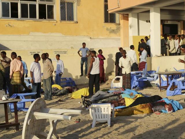 People search for friends and family amongst dead bodies on the beach, following an overnight attack on a beachfront restaurant in Mogadishu, Somalia, Friday, Jan. 22, 2016. Somalia's security forces ended a deadly siege of a beachfront restaurant in the capital, with many killed in the attack, a police official said Friday. (AP) People search for friends and family amongst dead bodies on the beach, following an overnight attack on a beachfront restaurant in Mogadishu, Somalia, Friday, Jan. 22, 2016. Somalia's security forces ended a deadly siege of a beachfront restaurant in the capital, with many killed in the attack, a police official said Friday. (AP)