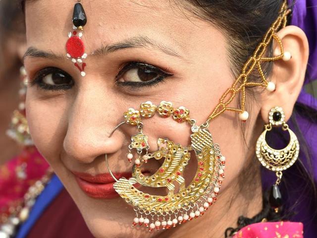 An artist from Uttarakhand poses for the cameras during a press preview of tableaux participating in this year’s Republic Day parade in Delhi. (Ajay Aggarwal/ HT Photo)