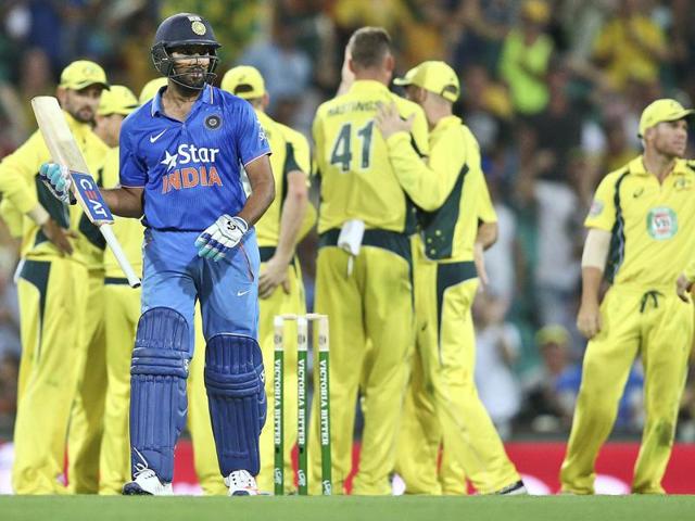 Australian team members celebrate as India's Rohit Sharma walks off the field. (AP Photo) Australian team members celebrate as India's Rohit Sharma walks off the field. (AP Photo)