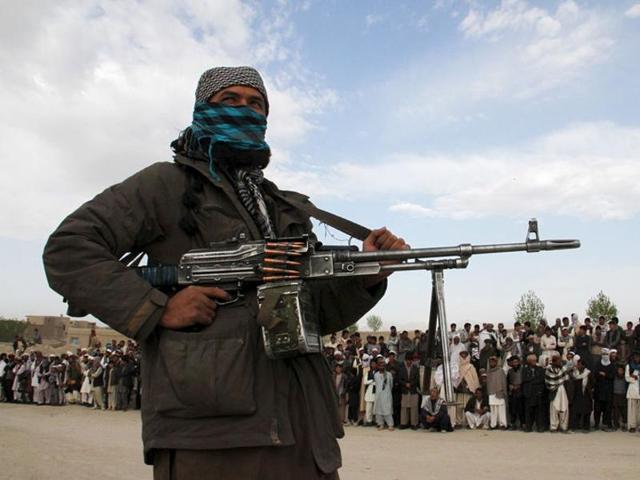 A member of the Taliban insurgent and other people stand at a site in Ghazni Province. (Reuters File) A member of the Taliban insurgent and other people stand at a site in Ghazni Province. (Reuters File)