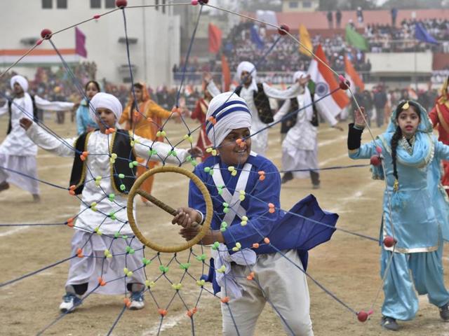 A school student performs gatka while others dance at Guru Nanak Dev Stadium, Amritsar on Saturday. (Gurpreet Singh/HT Photo) 