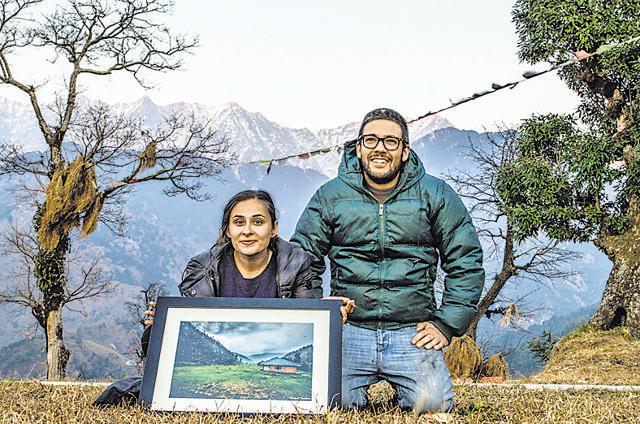 Tourists pose with one of Abhinav Chandel’s prints in Mcleodganj, Himachal Pradesh