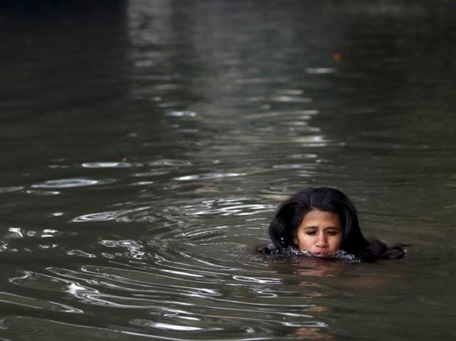 A dip of faith: A woman devotee takes a holy bath in River Sali in Sankhu during the Swasthani Brata Katha festival in Kathmandu. (Navesh Chitrakar/Reuters) A dip of faith: A woman devotee takes a holy bath in River Sali in Sankhu during the Swasthani Brata Katha festival in Kathmandu. (Navesh Chitrakar/Reuters)