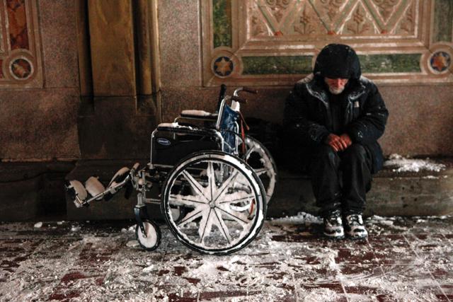 A Homeless covers from the snow in Central park on January 23, 2016 in New York. (AFP)