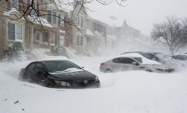 Blowing snow forms drifts around parked cars in William County, Virginia. (AFP) Blowing snow forms drifts around parked cars in William County, Virginia. (AFP)