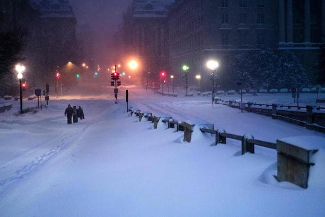 Independence Avenue is seen covered in snow as people walk after a snowstorm on Saturday in Washington. (AFP)