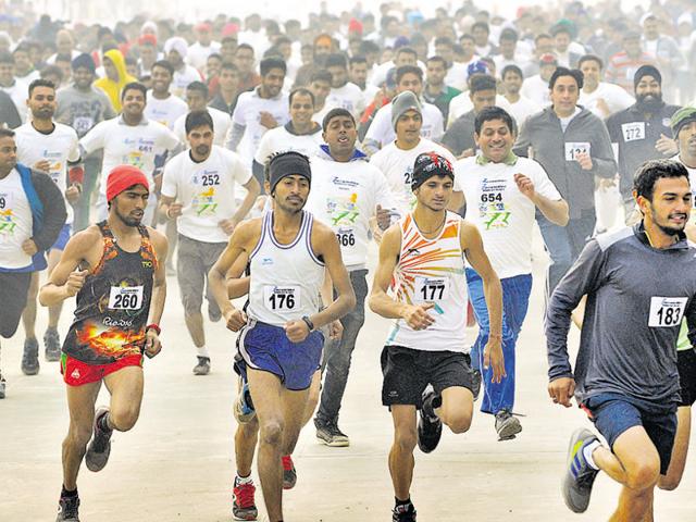 Participants during a mini-marathon at the Sector-78 stadium in SAS Nagar on Sunday.(Gurminder Singh/HT Photo)