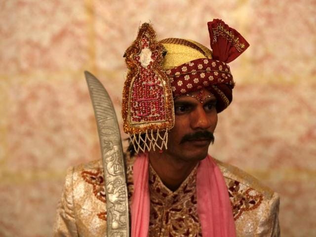 A groom in traditional dress waits for his wedding to start. (REUTERS)