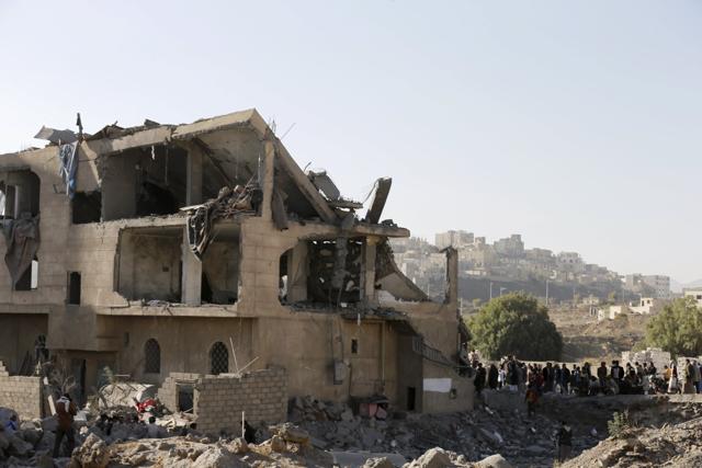 People gather outside the house of court judge Yahya Rubaid after a Saudi-led air strike destroyed it, killing him, his wife and five other family members, in Yemen's capital Sanaa on Monday.(REUTERS) People gather outside the house of court judge Yahya Rubaid after a Saudi-led air strike destroyed it, killing him, his wife and five other family members, in Yemen's capital Sanaa on Monday.(REUTERS)