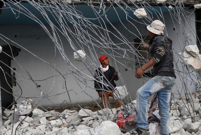 Palestinian workers remove debris from buildings destroyed in the war between Israel and Hamas militants. (AFP) Palestinian workers remove debris from buildings destroyed in the war between Israel and Hamas militants. (AFP)