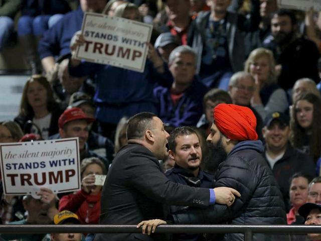 A protester (front on R) is escorted out of a US Republican presidential candidate Donald Trump campaign event in Muscatine, Iowa. (REUTERS) A protester (front on R) is escorted out of a US Republican presidential candidate Donald Trump campaign event in Muscatine, Iowa. (REUTERS)