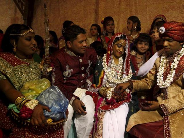 A bride and groom couple go through a ritual. Some 60 Hindu couples took part in a mass wedding ceremony organised by the Pakistan Hindu Council. (REUTERS)