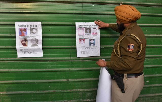 Delhi police officer sticking posters of terrorists on the streets of capital on Sunday January 24, 2016. (Raj K Raj / HT Photo ) Delhi police officer sticking posters of terrorists on the streets of capital on Sunday January 24, 2016. (Raj K Raj / HT Photo )