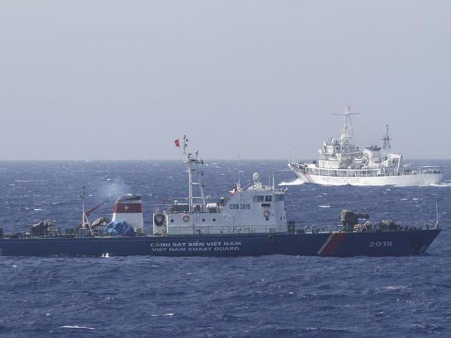A file photo of a ship (top) of the Chinese Coast Guard seen near a ship of the Vietnam Marine Guard in the South China Sea, about 210 km off the shore of Vietnam.(REUTERS) A file photo of a ship (top) of the Chinese Coast Guard seen near a ship of the Vietnam Marine Guard in the South China Sea, about 210 km off the shore of Vietnam.(REUTERS)