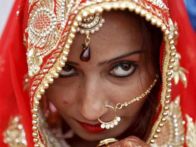 A Muslim bride watches during a mass wedding ceremony in Ahmedabad, India, January 22, 2016. (REUTERS)