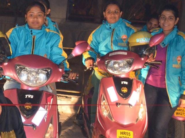 Commuters using the Bikxie Pink , a women-only two-wheeler taxi service which is the first-of-its-kind service in India that offers a fleet of Scooties driven only by women drivers.(HT Photo)