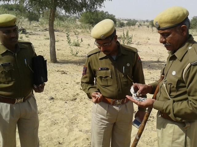 Police officials examine the remains of a balloon-shaped object which was shot down by an IAF fighter jet in Barmer on Tuesday.(HT Photo) Police officials examine the remains of a balloon-shaped object which was shot down by an IAF fighter jet in Barmer on Tuesday.(HT Photo)