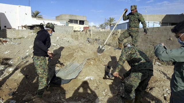 Iraqi security forces members work at the site of a mass grave grave believed to contain the bodies of Iraqi civilians killed by Islamic State group militants in Ramadi, 115 kilometers (70 miles) west of Baghdad.(AP Photo) (AP) Iraqi security forces members work at the site of a mass grave grave believed to contain the bodies of Iraqi civilians killed by Islamic State group militants in Ramadi, 115 kilometers (70 miles) west of Baghdad.(AP Photo) (AP)