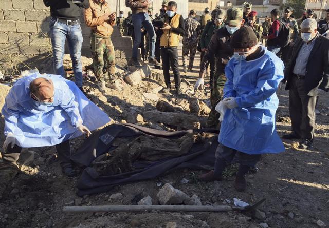 Iraqi forensic team members work at the site of a mass graven believed to contain the bodies of Iraqi civilians killed by Islamic State group militants in Ramadi, 115 kilometers (70 miles) west of Baghdad, Iraq, Monday. (AP) Iraqi forensic team members work at the site of a mass graven believed to contain the bodies of Iraqi civilians killed by Islamic State group militants in Ramadi, 115 kilometers (70 miles) west of Baghdad, Iraq, Monday. (AP)