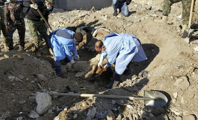 Iraqi forensic team members work at the site of a mass grave believed to contain the bodies of Iraqi civilians killed by Islamic State group militants in Ramadi, 115 kilometers (70 miles) west of Baghdad, Iraq, Monday. (AP) Iraqi forensic team members work at the site of a mass grave believed to contain the bodies of Iraqi civilians killed by Islamic State group militants in Ramadi, 115 kilometers (70 miles) west of Baghdad, Iraq, Monday. (AP)