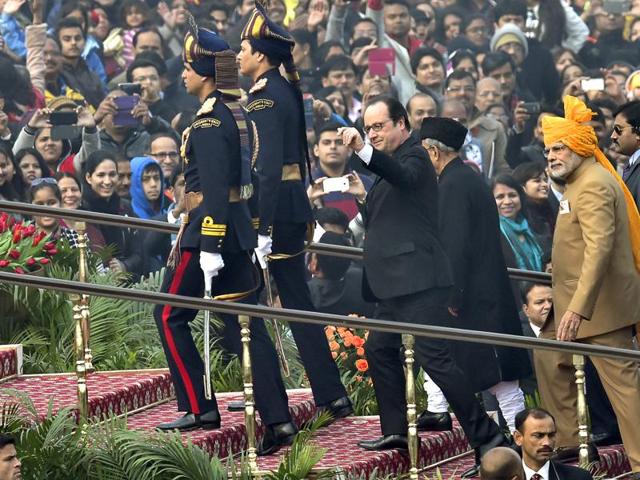 French President Francois Hollande (C) and Prime Minister Narendra Modi (R) arrive at the Republic Day parade, in New Delhi. Hollande was the guest of honour for this year’s celebration of the 67th Republic Day.  (Ajay Aggarwal/HT Photo) 