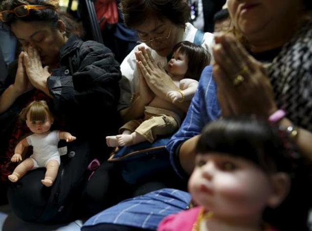 The plastic dolls, about the size of a real baby, are called “look thep”, or “child angel”. (Reuters) The plastic dolls, about the size of a real baby, are called “look thep”, or “child angel”. (Reuters)