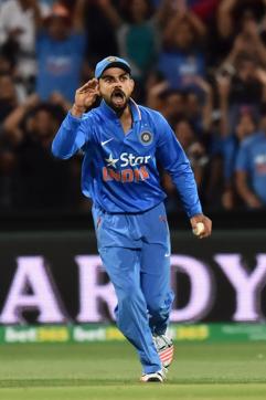 Virat Kohli makes a chatterbox gesture after taking a catch to dismiss Steven Smith. (Getty Images)