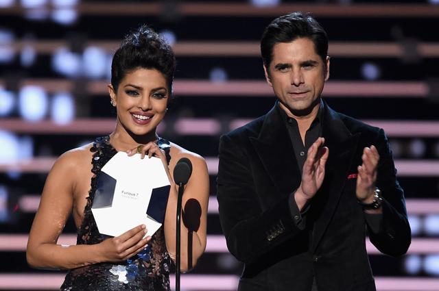 Actors Priyanka Chopra (L) and John Stamos speak onstage during the People's Choice Awards 2016 at Microsoft Theater on January 6, 2016 in Los Angeles, California. (AFP) Actors Priyanka Chopra (L) and John Stamos speak onstage during the People's Choice Awards 2016 at Microsoft Theater on January 6, 2016 in Los Angeles, California. (AFP)