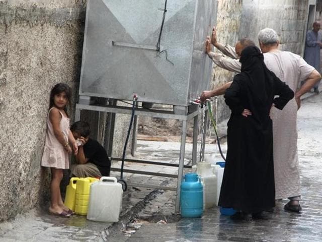 Residents fill water containers in Aleppo, Syria. (Reuters) Residents fill water containers in Aleppo, Syria. (Reuters)