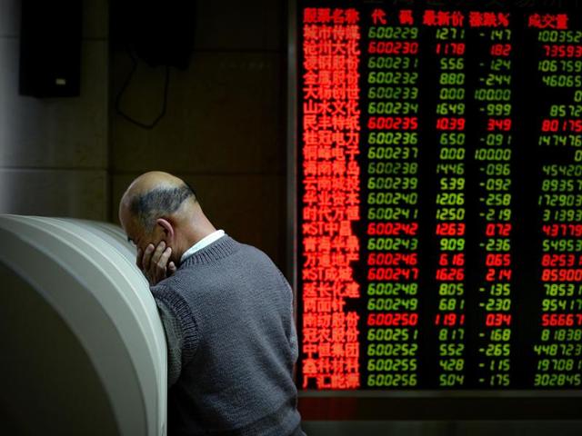 An investor uses a computer terminal to check stock prices at a securities company in Beijing. (AFP File Photo) An investor uses a computer terminal to check stock prices at a securities company in Beijing. (AFP File Photo)