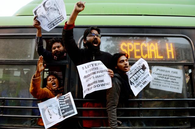 Students shout slogans from a bus after they were detained by police outside the office of HRD Minister Smriti Irani during a protest on January 28 in Delhi against the death of Rohith Vemula. (AFP)