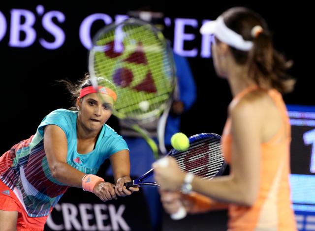 Sania Mirza of India plays a return as her partner Martina Hingis of Switzerland watches during their match against Czech Republic’s Andrea Hlavackova and Lucie Hradecka in the women's doubles final. (AP) Sania Mirza of India plays a return as her partner Martina Hingis of Switzerland watches during their match against Czech Republic’s Andrea Hlavackova and Lucie Hradecka in the women's doubles final. (AP)