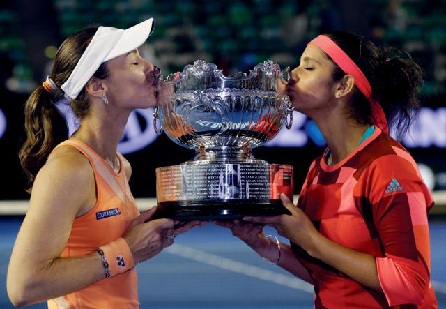 Martina Hingis, left, of Switzerland and Sania Mirza of India kiss their trophy after defeating Czech Republic’s Andrea Hlavackova and Lucie Hradecka in the women's doubles final. (AP) Martina Hingis, left, of Switzerland and Sania Mirza of India kiss their trophy after defeating Czech Republic’s Andrea Hlavackova and Lucie Hradecka in the women's doubles final. (AP)