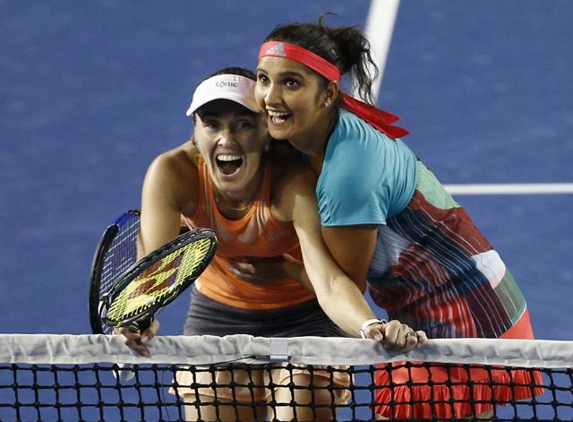 Sania Mirza, right, of India embraces her partner Martina Hingis of Switzerland as they watch a replay on a disputed line call. (AP) Sania Mirza, right, of India embraces her partner Martina Hingis of Switzerland as they watch a replay on a disputed line call. (AP)