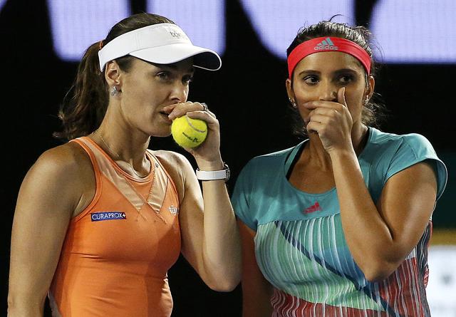 Switzerland's Martina Hingis (L) and India's Sania Mirza react during their doubles final match. (REUTERS) Switzerland's Martina Hingis (L) and India's Sania Mirza react during their doubles final match. (REUTERS)
