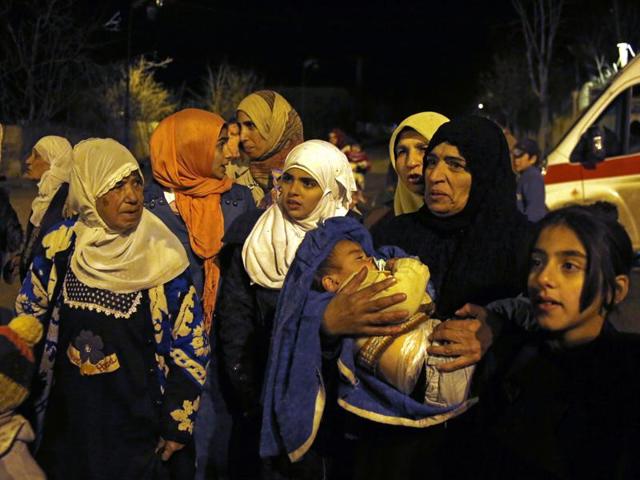 In this January 11, 2016 photo, people wait to leave the besieged town of Madaya, northwest of Damascus, Syria, where Doctors Without Borders says dozens of people have died of starvation since September. (AP) In this January 11, 2016 photo, people wait to leave the besieged town of Madaya, northwest of Damascus, Syria, where Doctors Without Borders says dozens of people have died of starvation since September. (AP)
